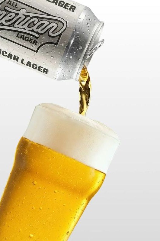 A can of All American Lager pouring into a pint glass