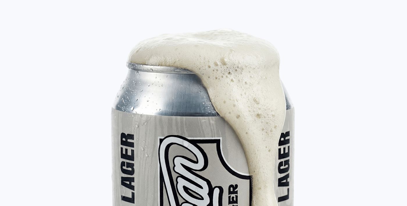 Foam spilling over the top of an All American Lager can