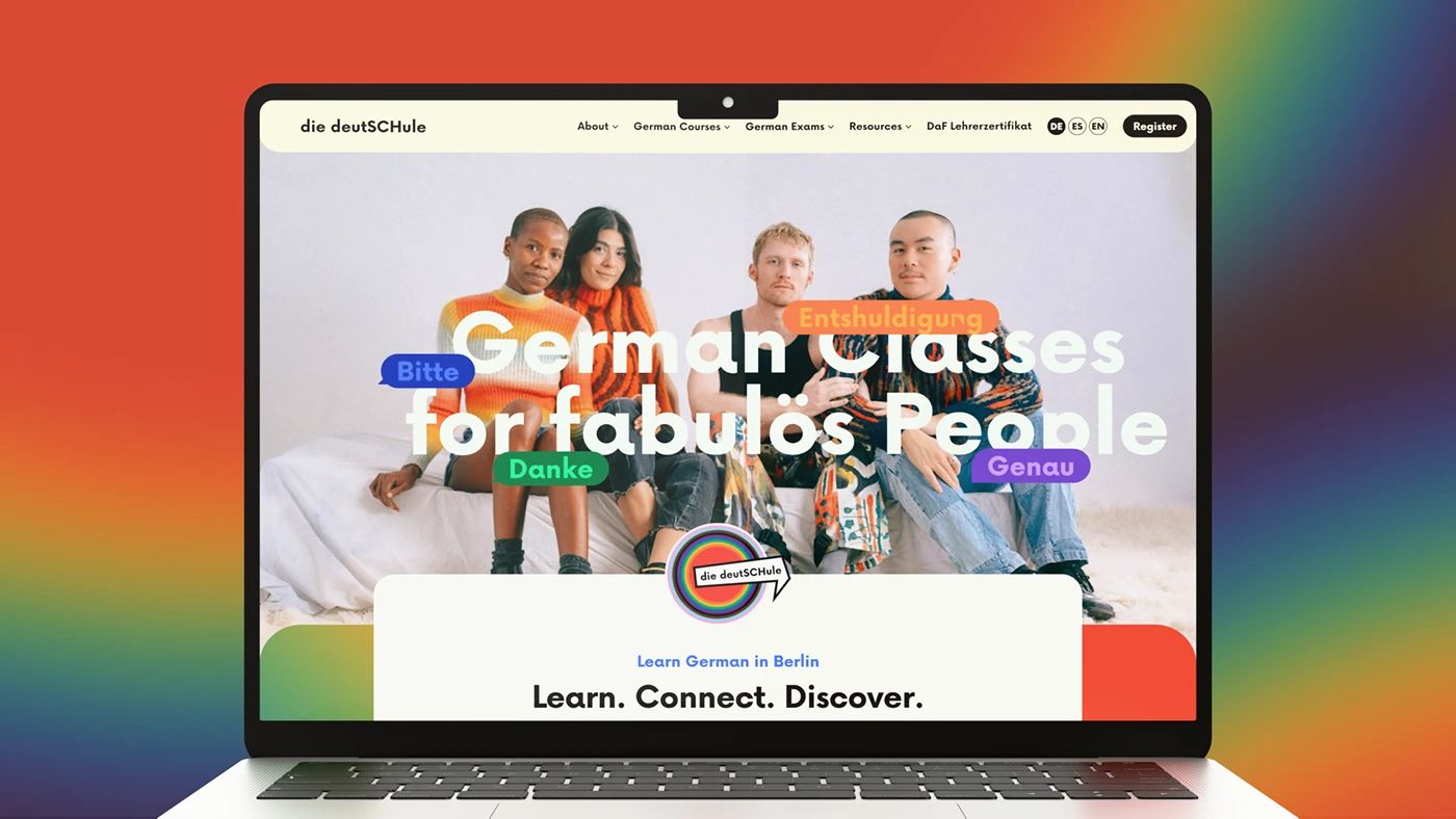 die deutSCHule homepage on a laptop against a rainbow gradient