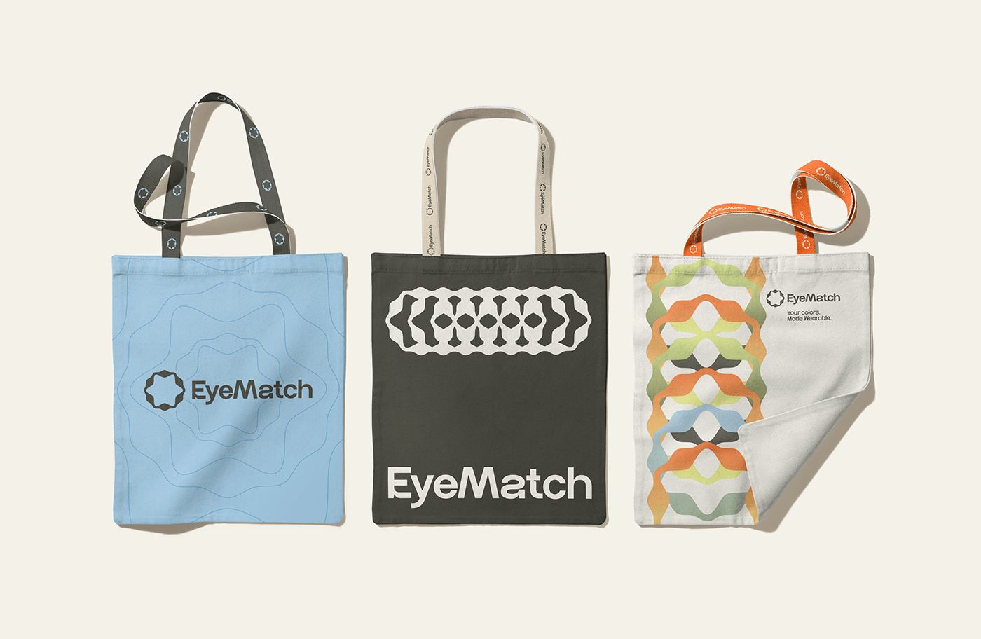 Three EyeMatch tote bags in blue, black and pattern