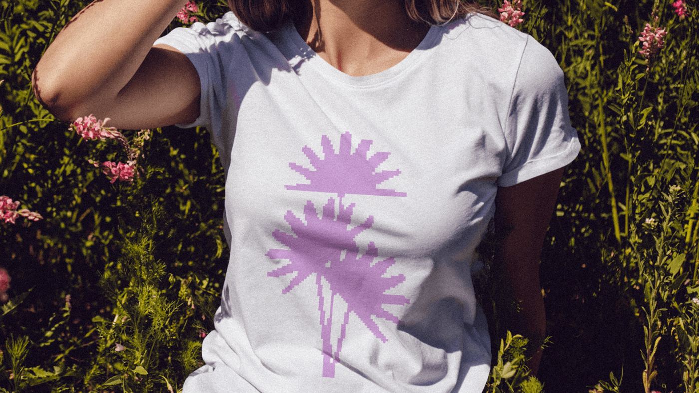 Model in a white tee with a lavender flower print, in a flower field