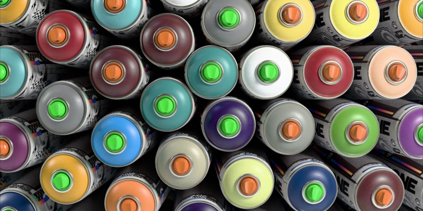Spray-paint cans seen from above, caps in every colour