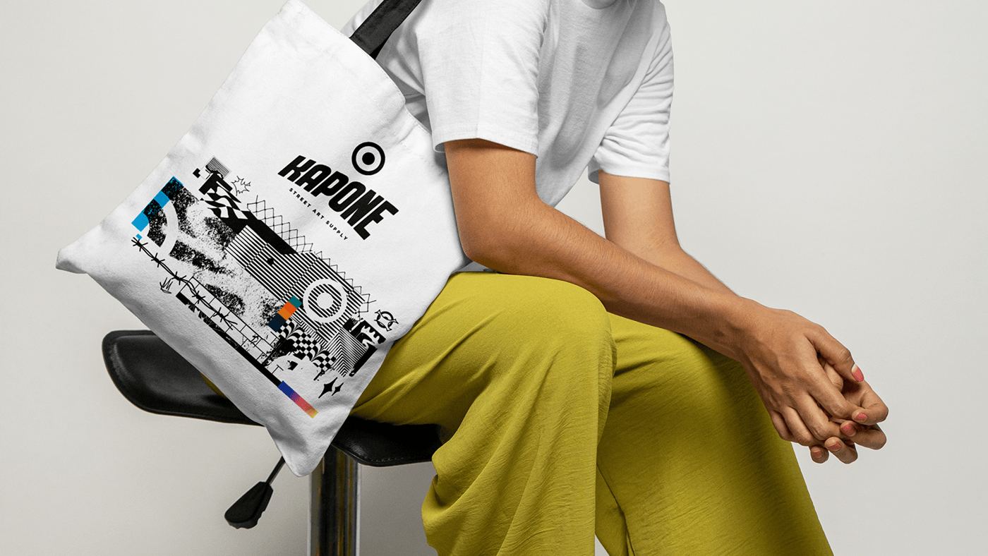A Kapone tote bag resting on a seated person's lap