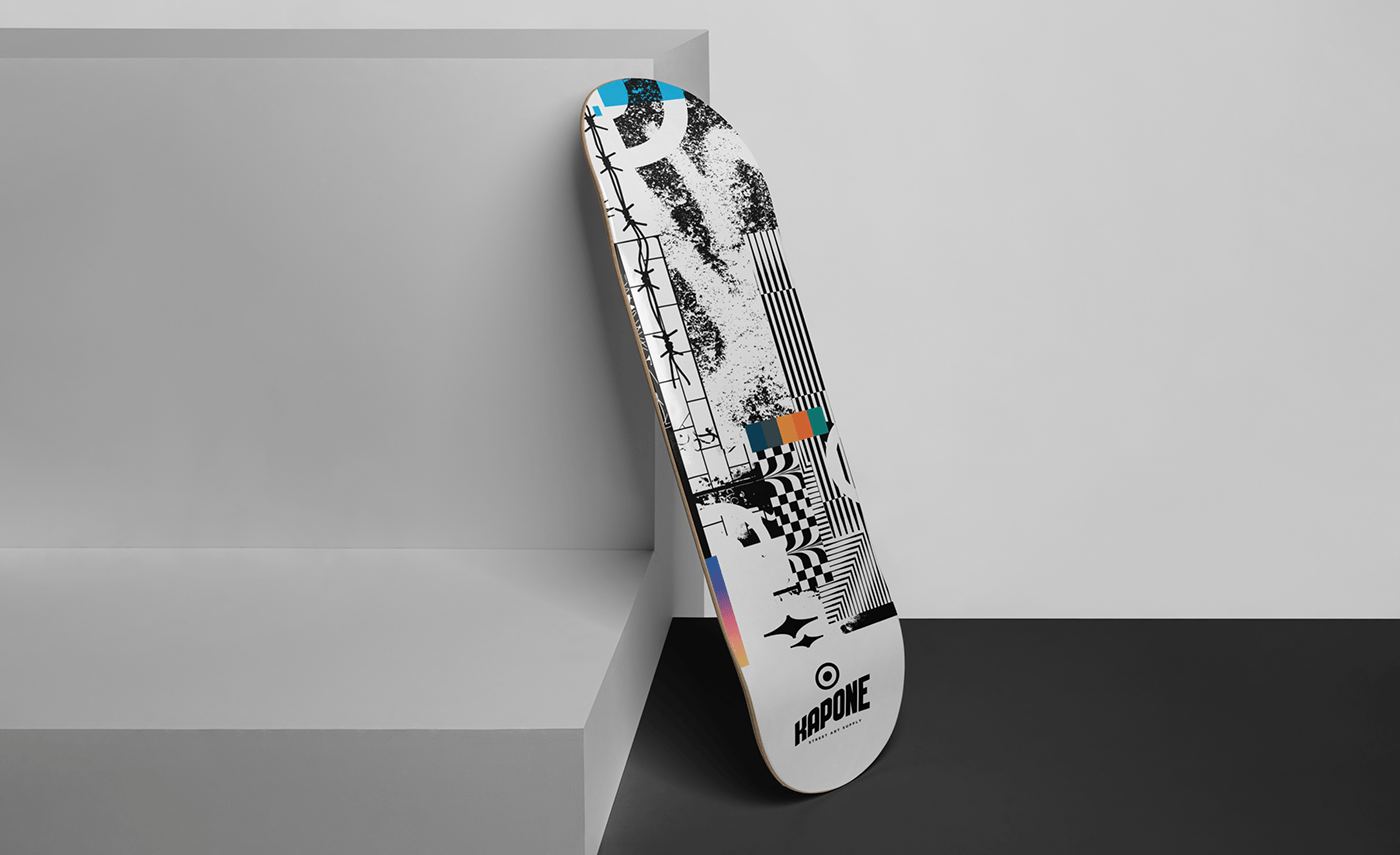 A skateboard deck with the Kapone collage leaning on a grey step