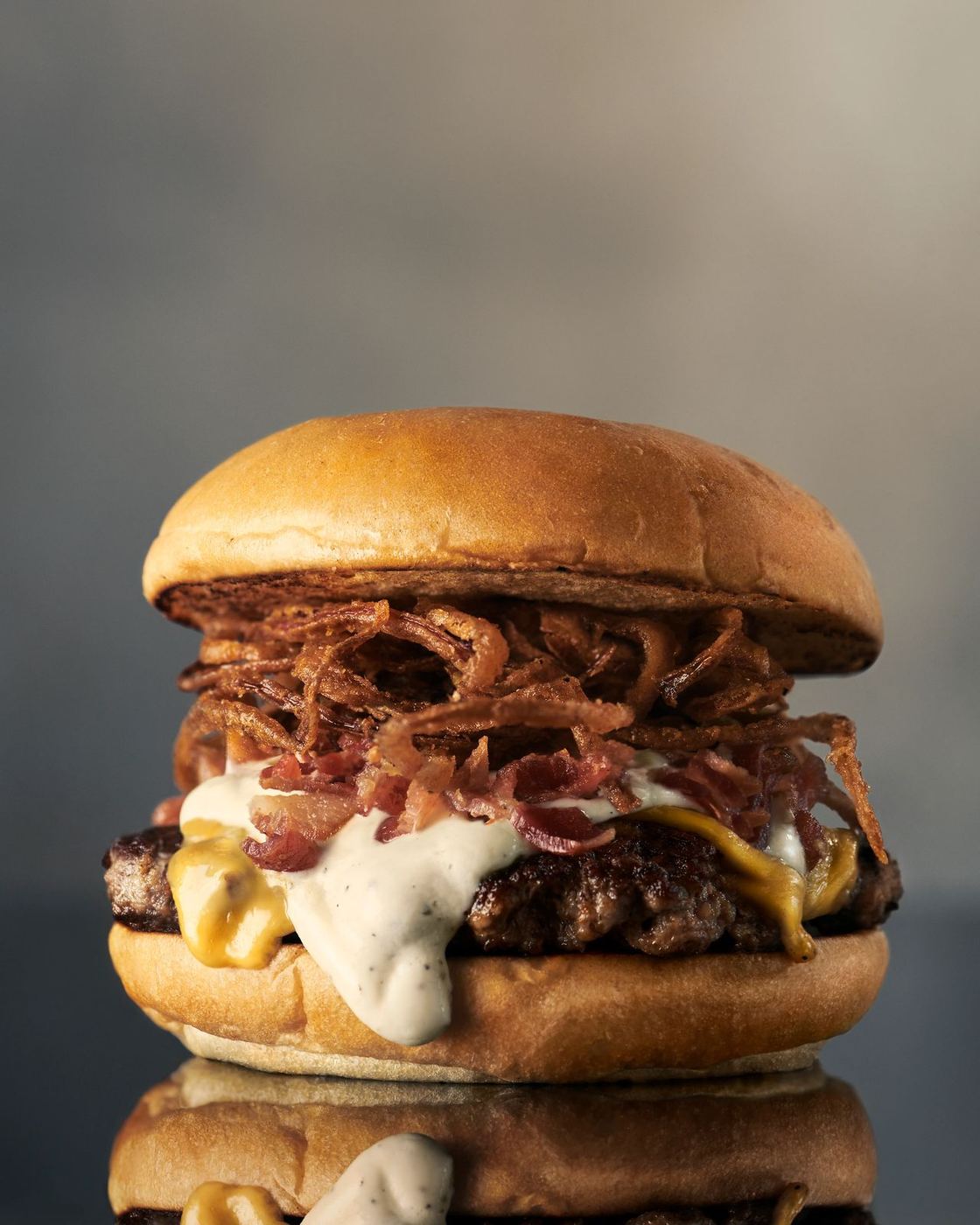 La Diosa burger standing on a reflective surface