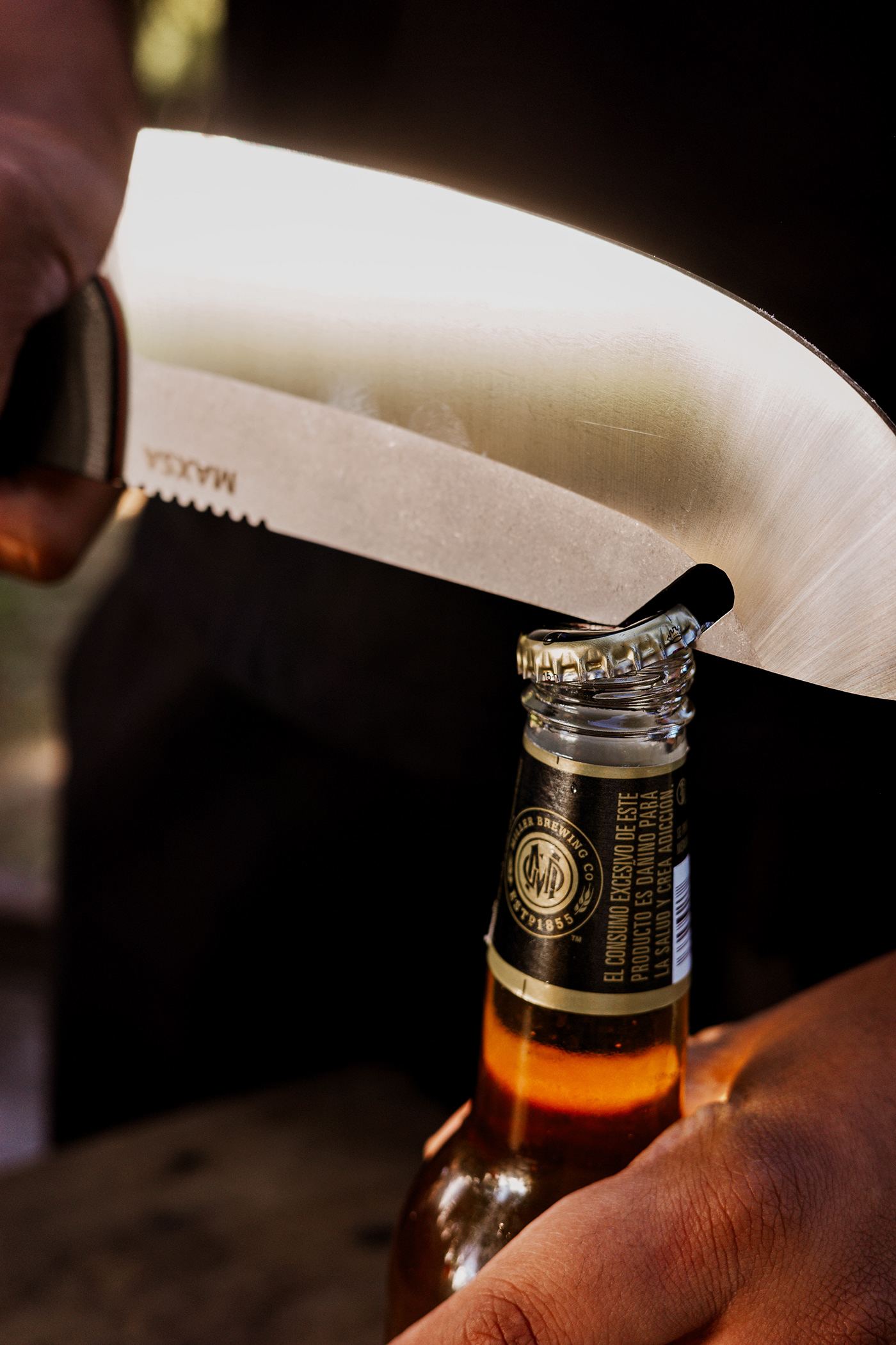 Opening a beer bottle with the MAXSA blade's built-in opener